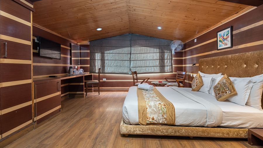 A bedroom with a sheer curtain covered  and a television